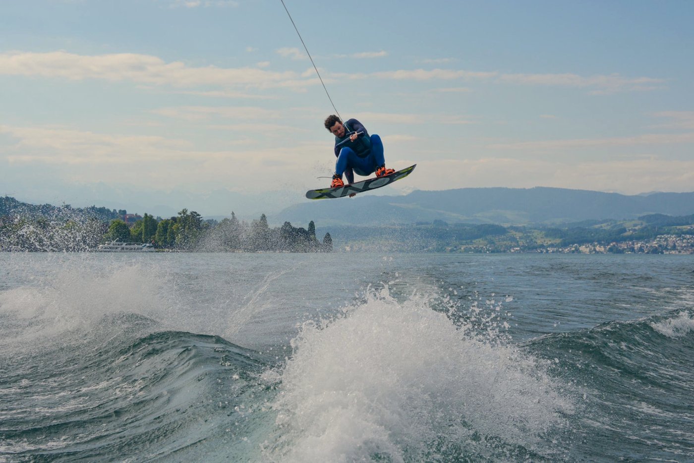 Wakeboarder flying high above the wake on Lake Zürich