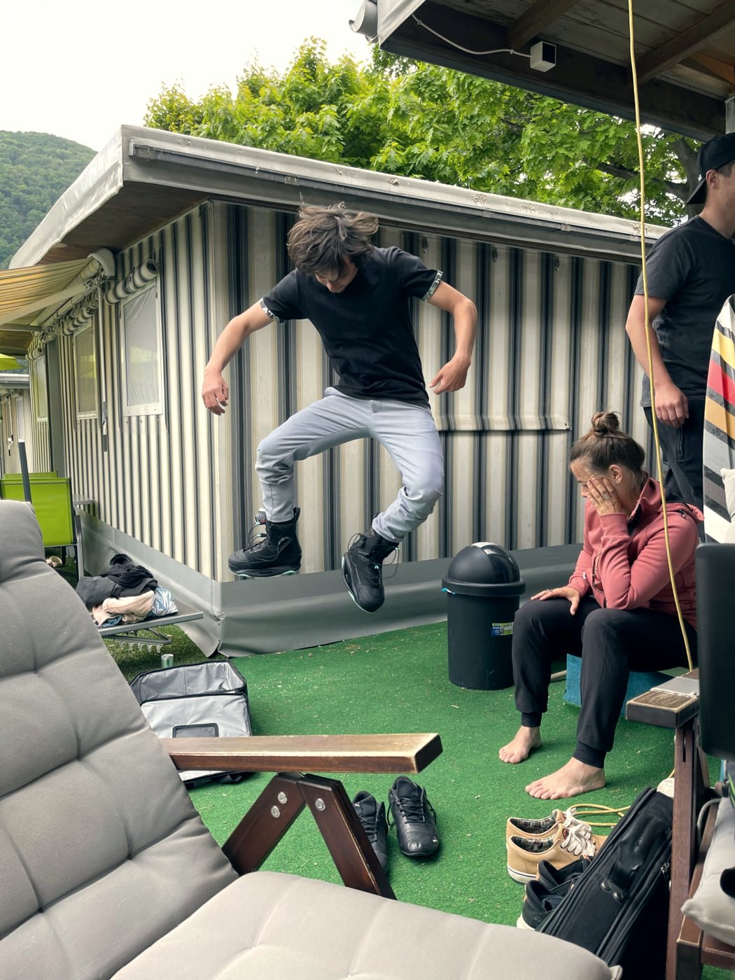 Rider practising a jump in wakeboard boots at the club camp